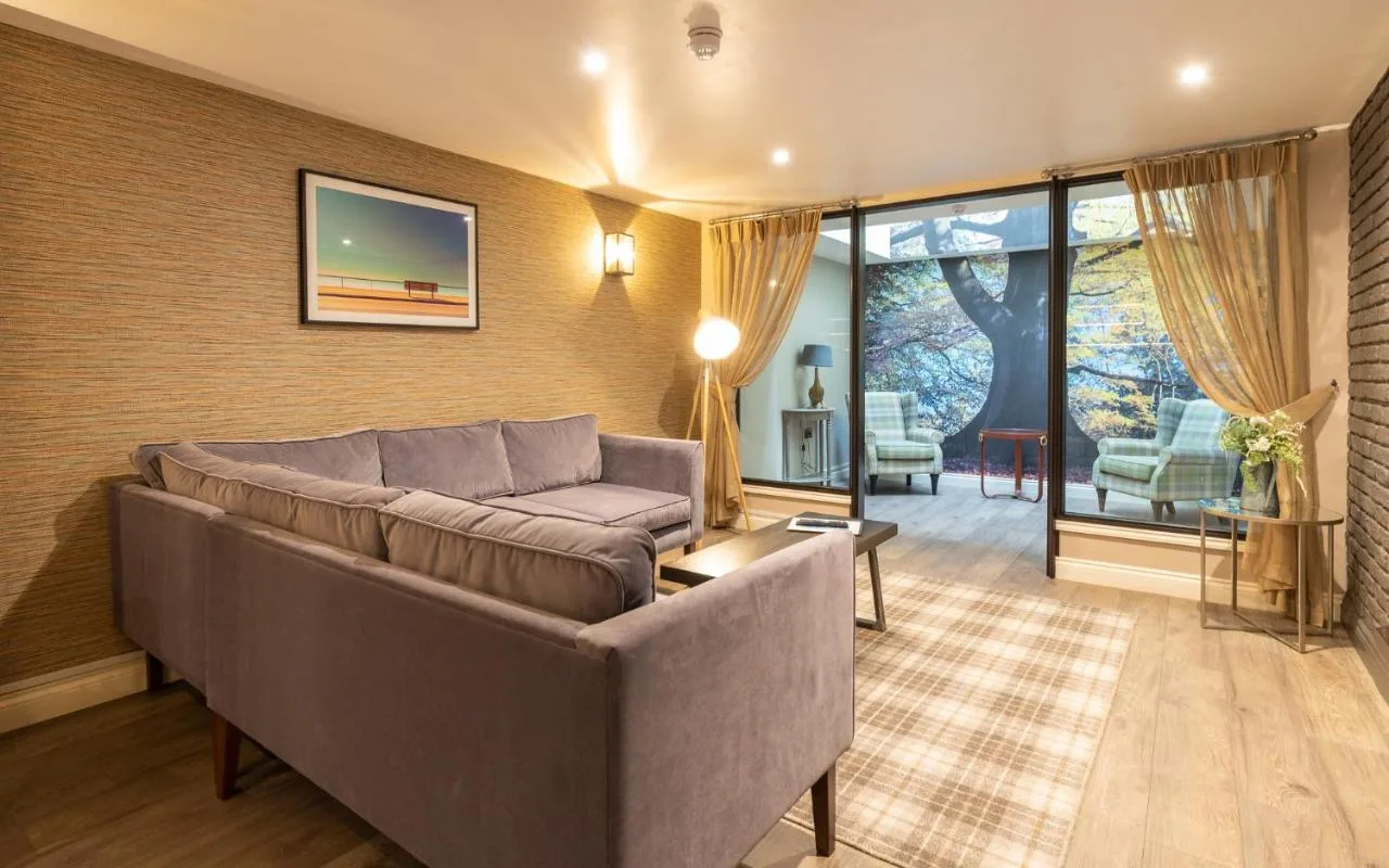 A living room with a sofa and table at The Lawrance Luxury Aparthotel on Micklegate, York