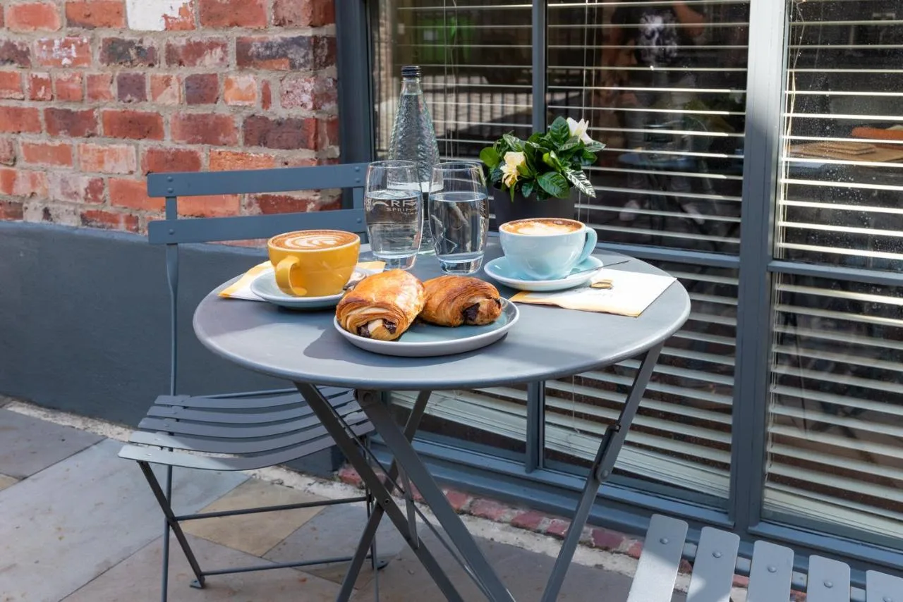 A table set with croissants and coffee at The Lawrance Luxury Aparthotel, York