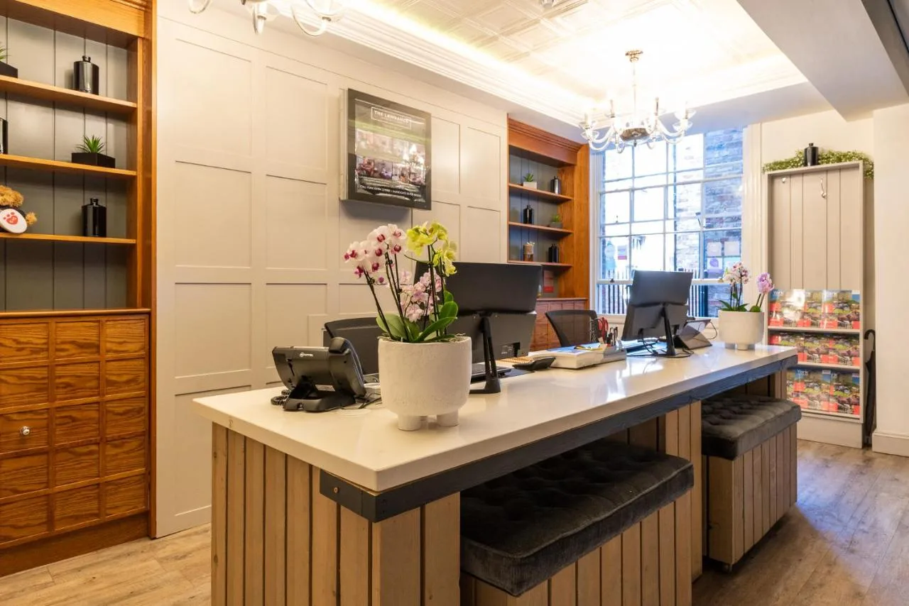 A work desk with fresh flowers at The Lawrance Luxury Aparthotel, York city centre